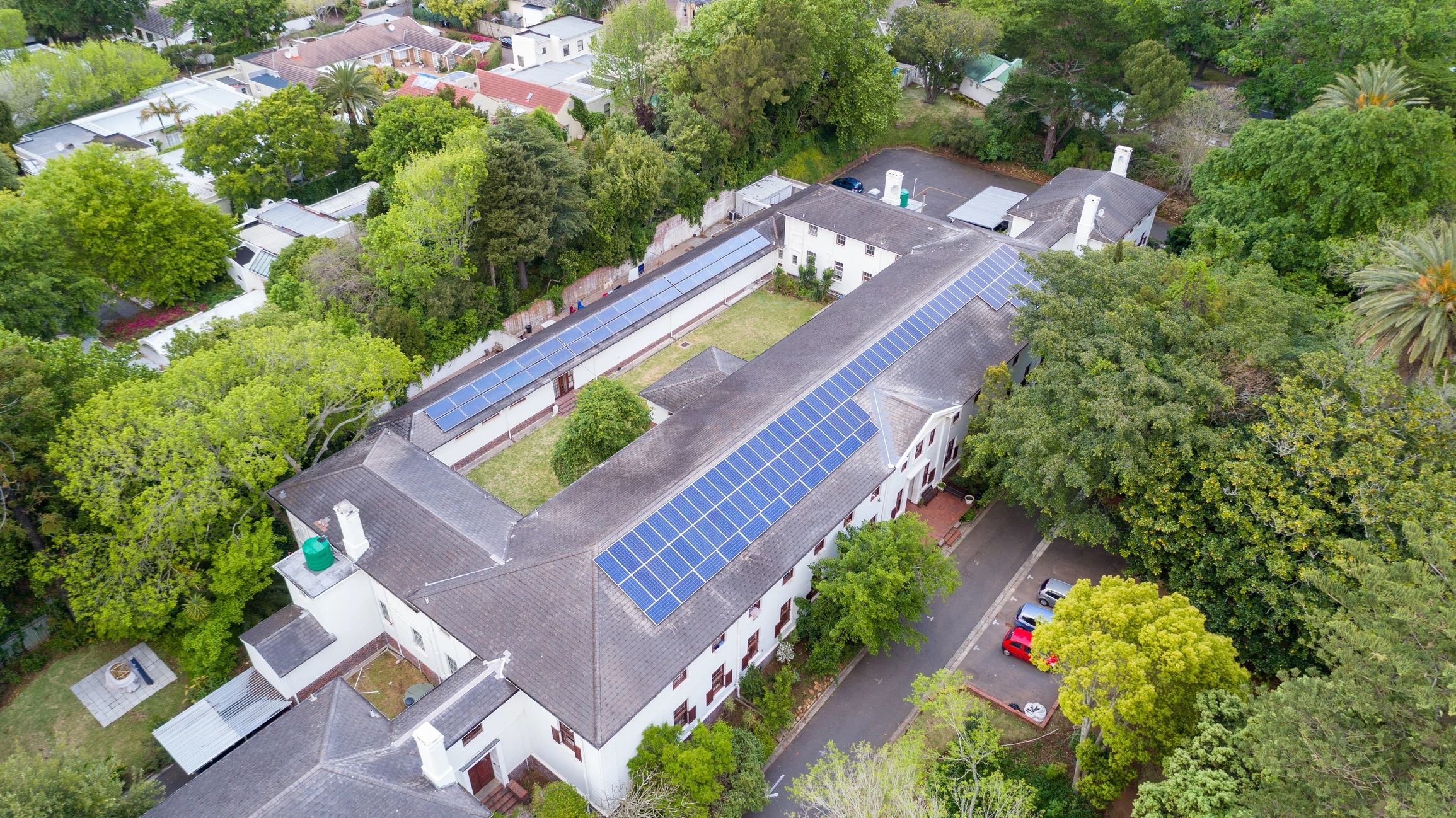 Solar panels line rooftop of old large building